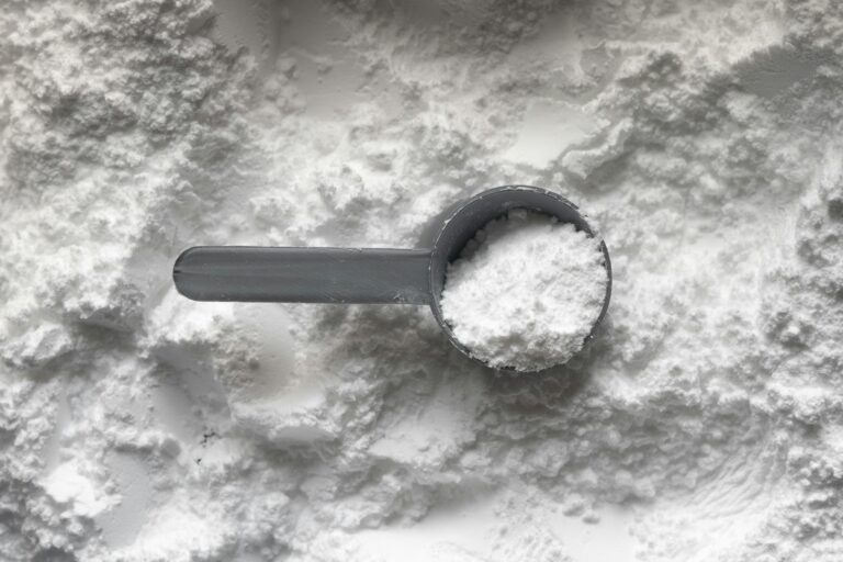Creatine monohydrate powder with a measuring scoop for men over 35