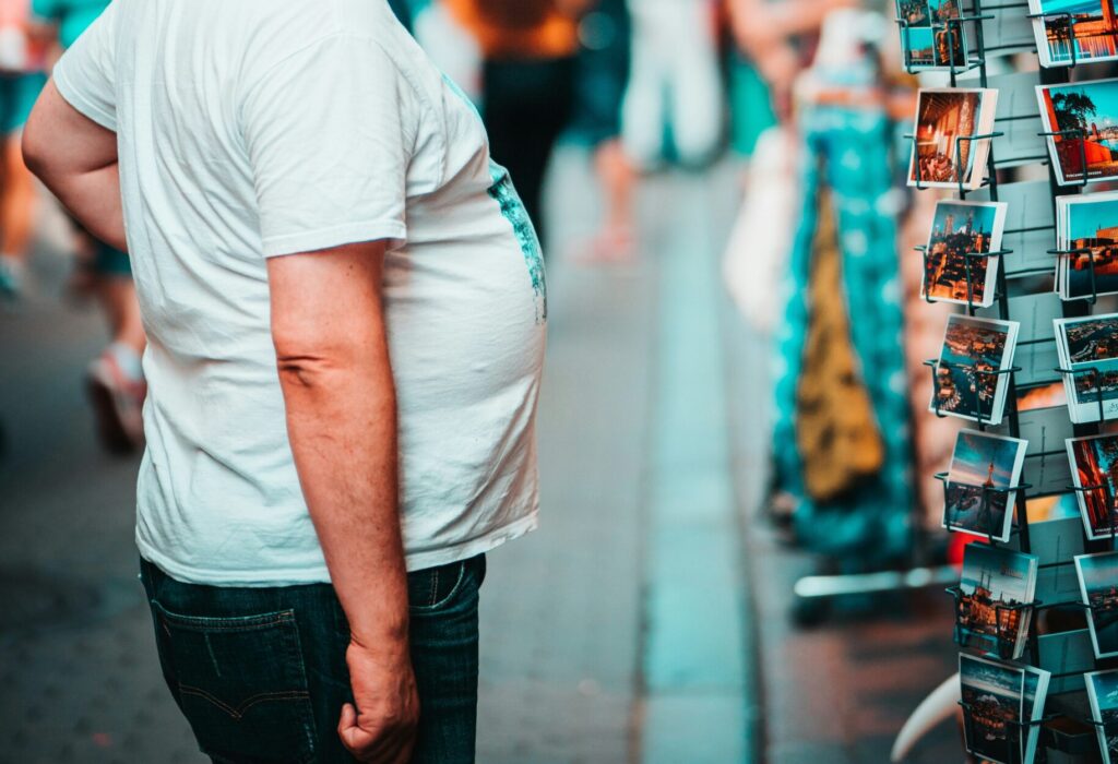 Man with dad bod belly walking showing the need for weight loss after 40