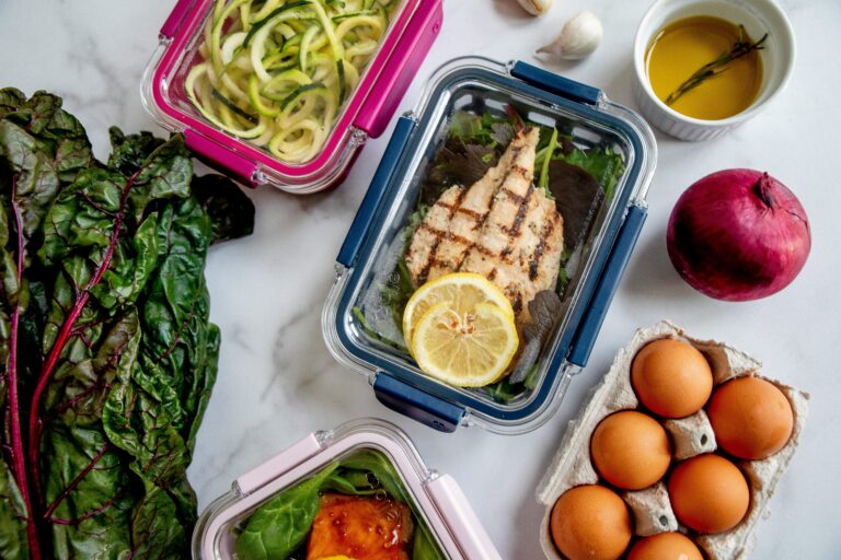 High protein meal prep containers with grilled chicken eggs and vegetables for busy dads